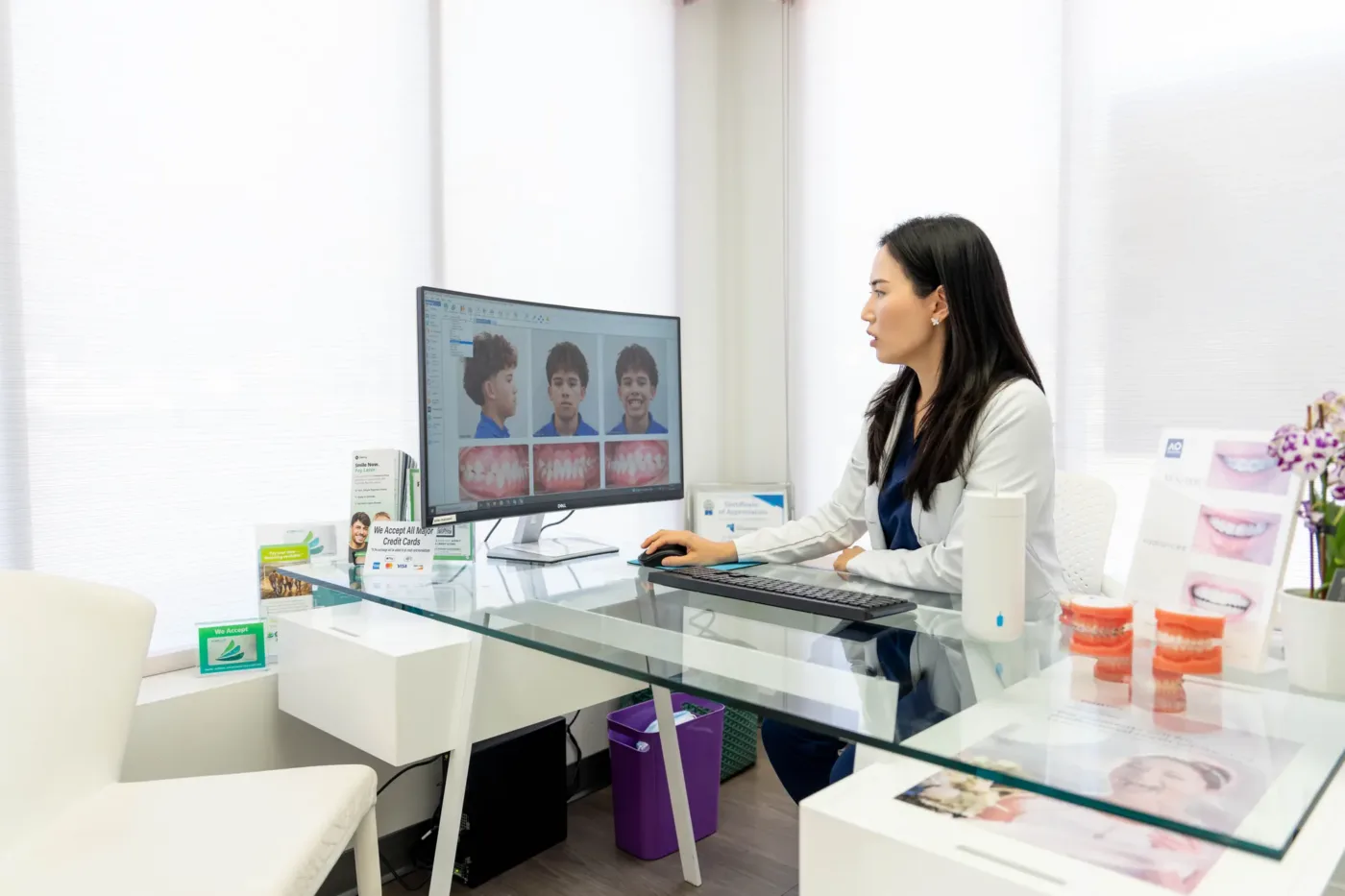 Orthodontist reviewing photos and X-rays at the consultation desk